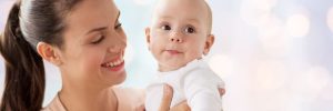 Happy mother and baby before baby blessing